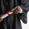 Mid section of man in graduation gown holding diploma
