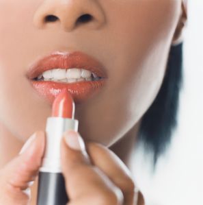Woman Putting on Lipstick