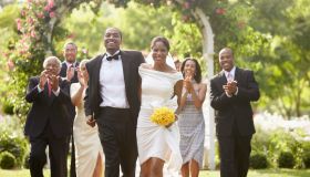 Wedding guests applauding newlyweds