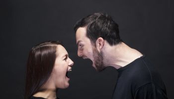 young man and woman shouting at each other