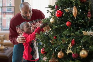Father and son decorating Christmas tree