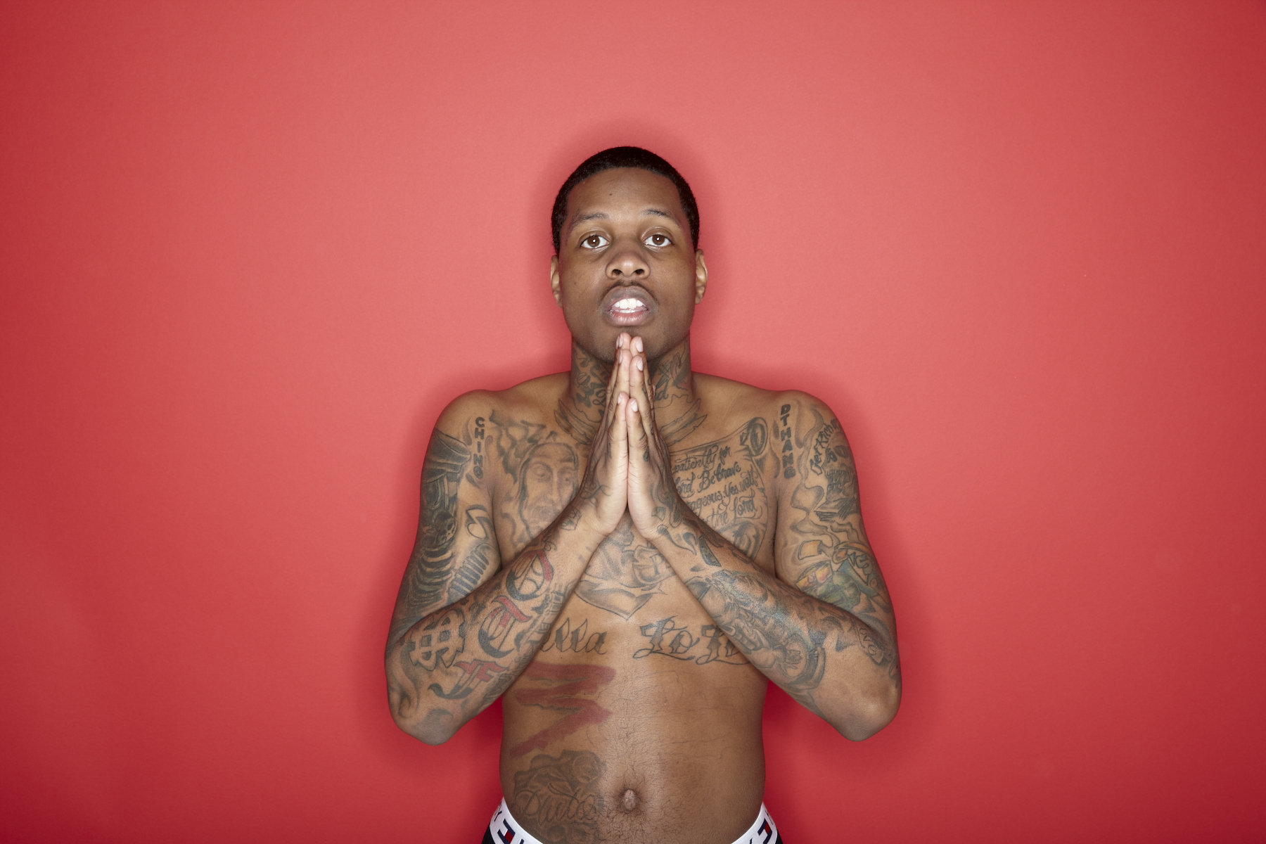 Download Lil Durk striking a pose in a stylish outfit | Wallpapers.com