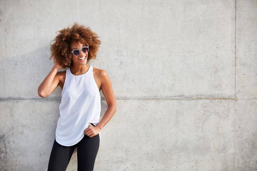 Happy woman wearing tank top and sunglasses