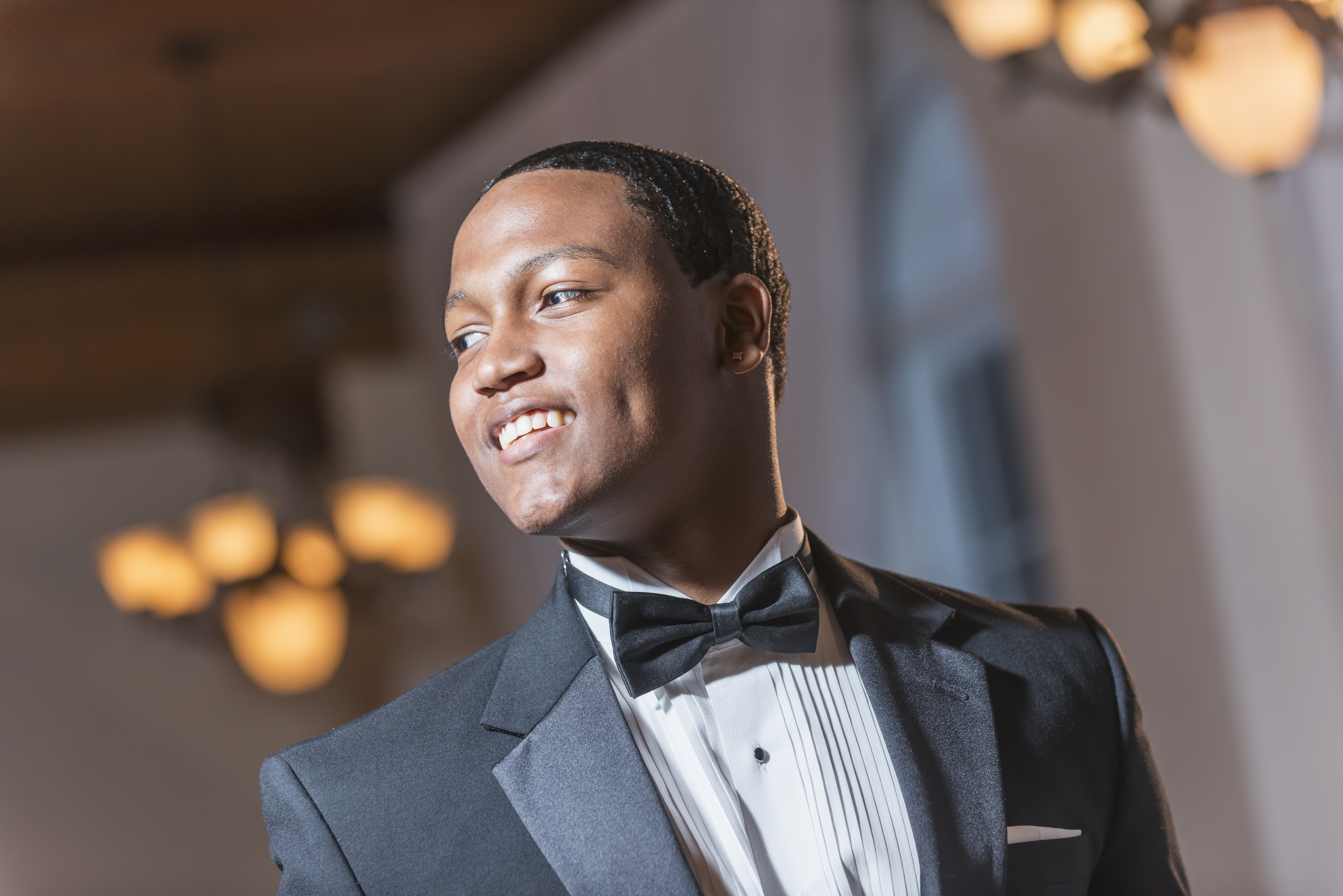 Young black Hispanic man wearing tuxedo