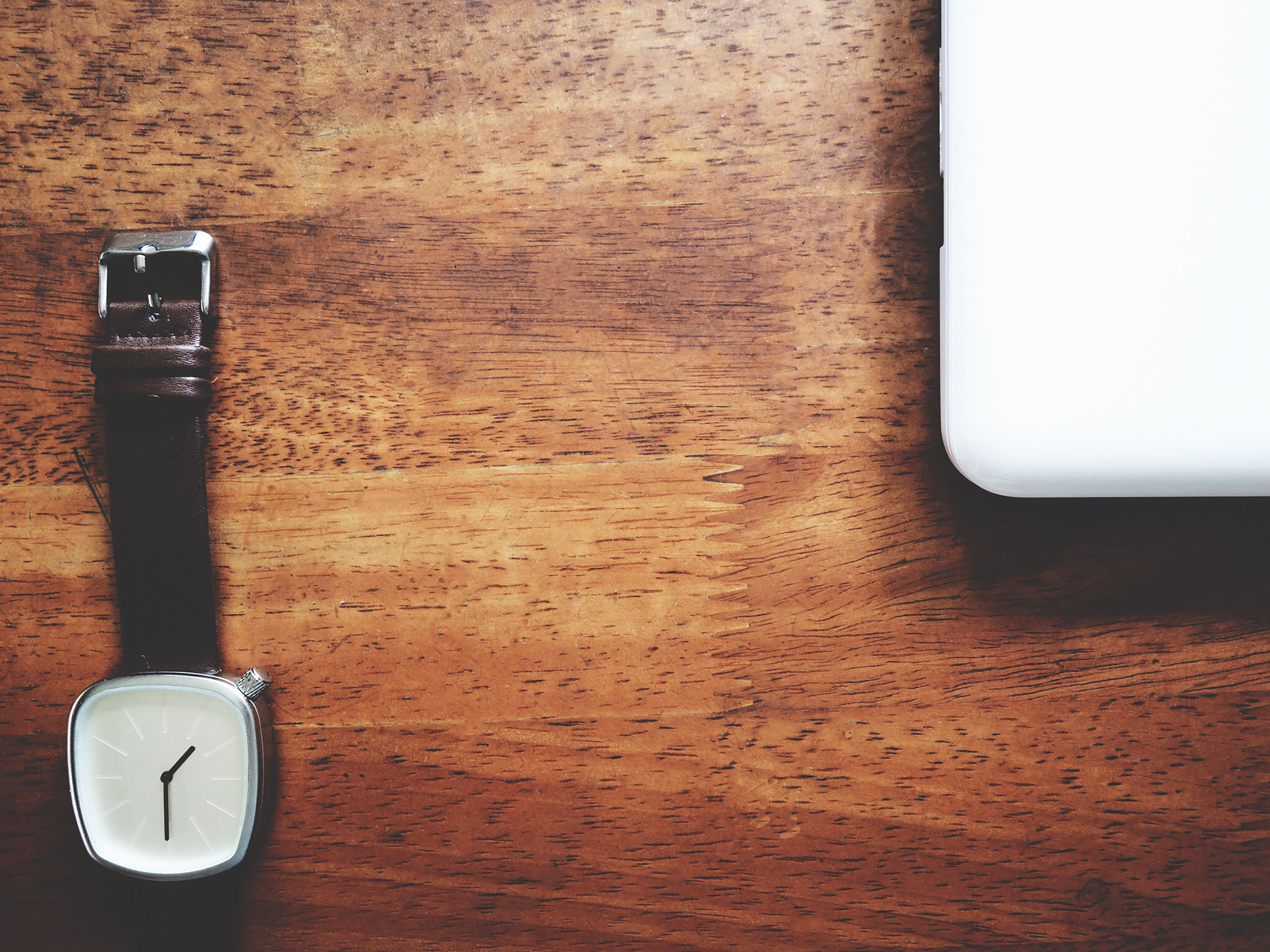 High Angle View Of Laptop And Wristwatch On Table