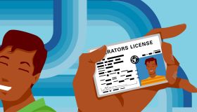 Teenage boy holding driving license