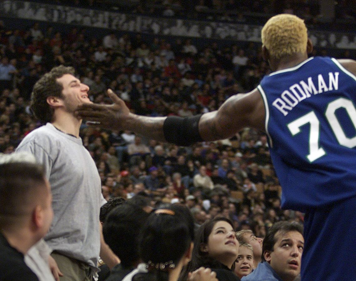 DIGITAL IMAGE-Ari Rozenzweig, of Toronto, gets a friendly slap on the chin by Dallas Mavericks' Denn