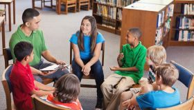 Young teacher leads after school club in library