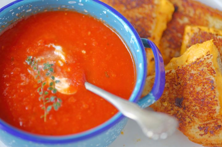 High Angle View Of Tomato Soup With Cheese Sandwich Served In Plate