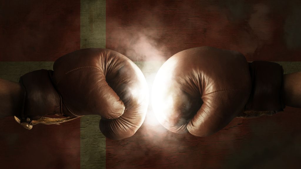 Cropped Image Of Boxers Fighting Against Illuminated Danish Flag