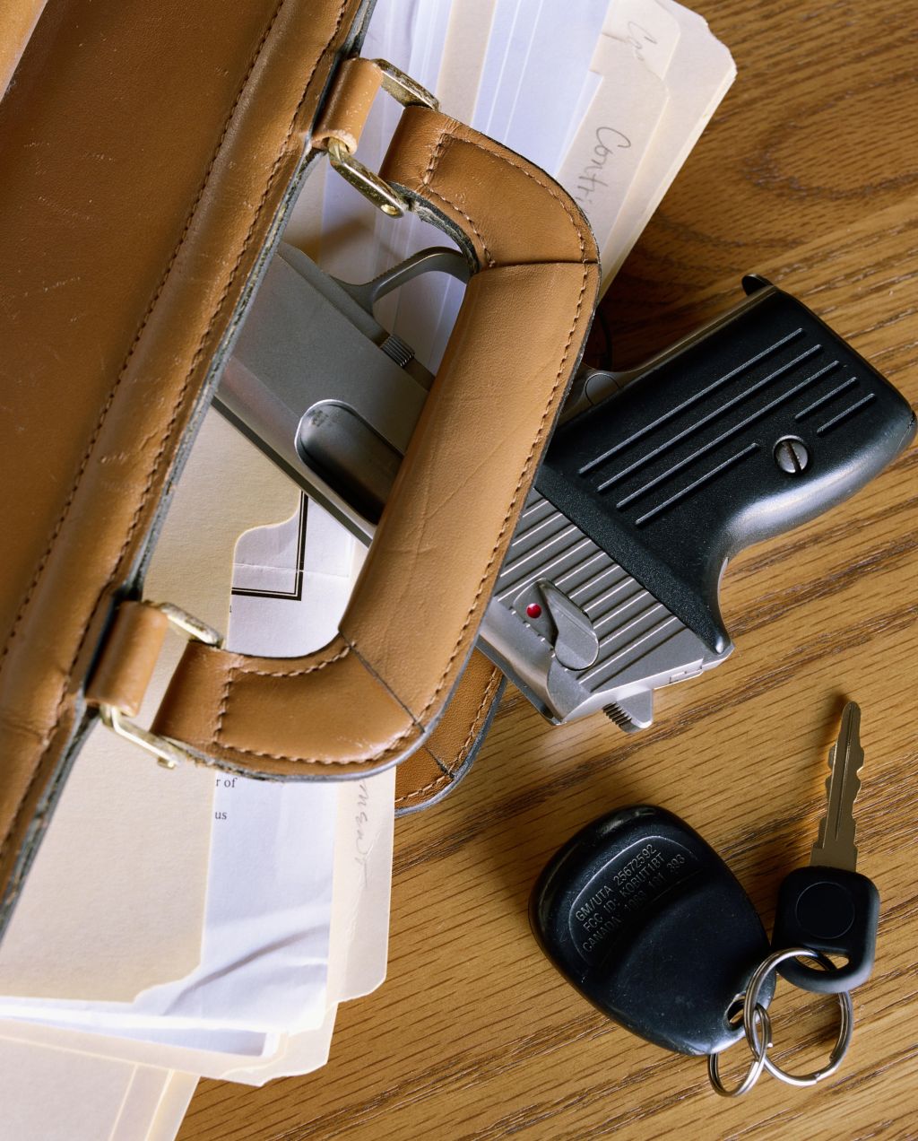 Pistol in briefcase, overhead view, close-up