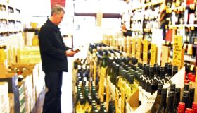 Man chooses wine in liquor store