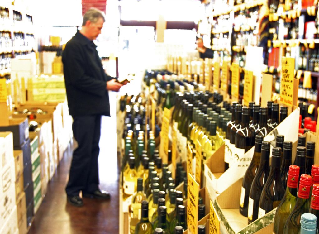 Man chooses wine in liquor store