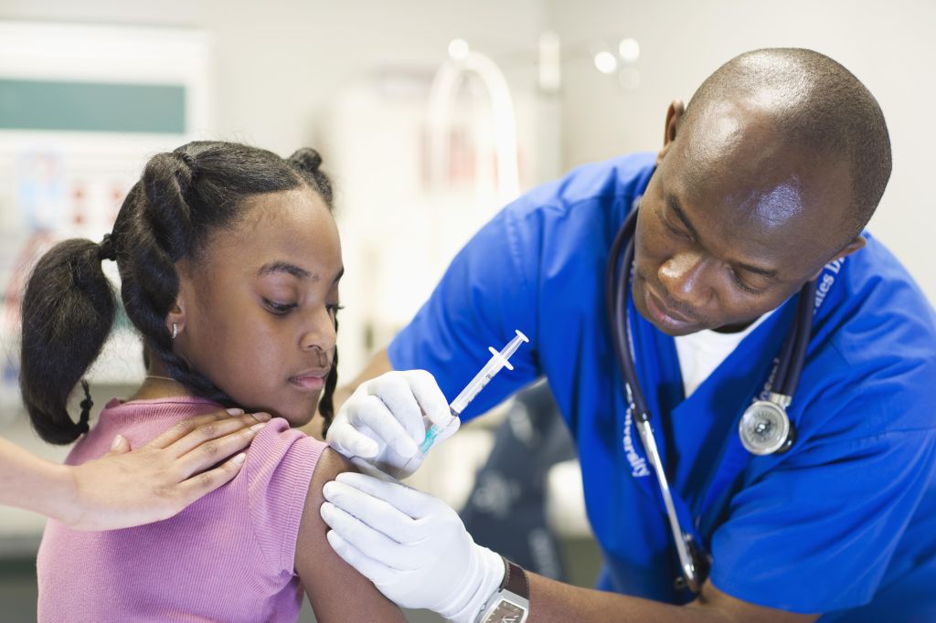 African American nurse giving patient injection