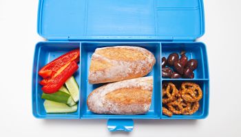 Healthy school or work lunch box with sandwich, vegetables and fruit in Australia
