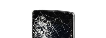 Mobile phone with broken glass on a white background.
