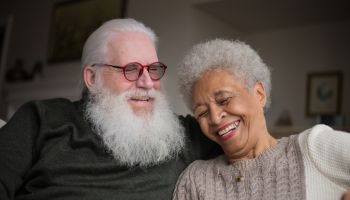 Elder Senior Couple Relaxing And Looking Out Window