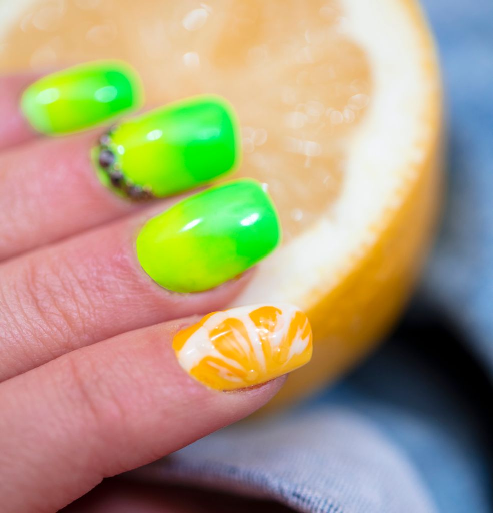 Close-Up Of Woman Fingers With Nail Art Manicure with neon green colour