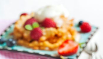 Funnel cakes with fresh berries and whipped cream