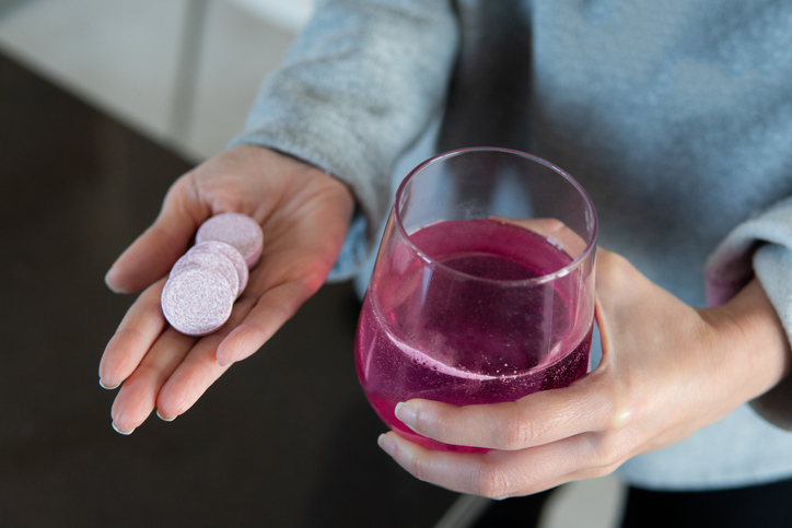 Woman holding effervescent tablets with her hand