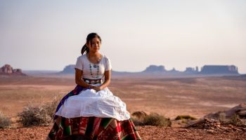 Portrait of a Beautiful Young Twelve Year Old Navajo Girl in Traditional Native American Clothing Posing in the Desert near the Monument Valley Tribal Park in Northern Arizona at Sunset or Sunrise