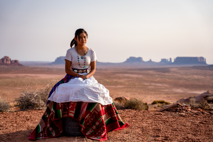 Portrait of a Beautiful Young Twelve Year Old Navajo Girl in Traditional Native American Clothing Posing in the Desert near the Monument Valley Tribal Park in Northern Arizona at Sunset or Sunrise