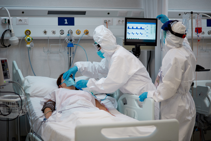 Medical Worker Adjusting Female Patient Oxygen Mask