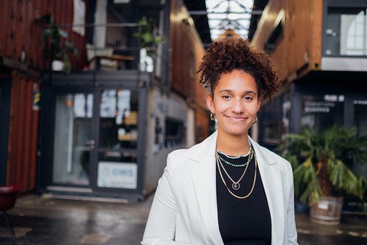 Portrait of multi-racial businesswoman in modern co-working space