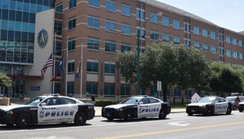 Three Dallas Police cars on South Lamar Street in front of Dallas Police headquarters on 8th July, 2016