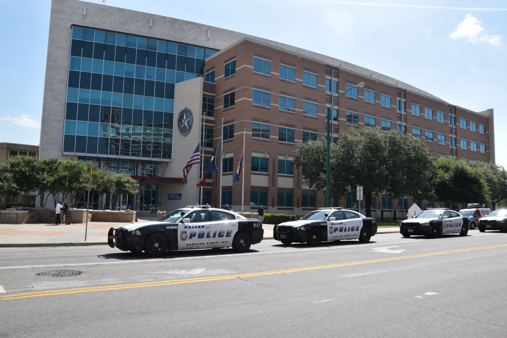Three Dallas Police cars on South Lamar Street in front of Dallas Police headquarters on 8th July, 2016
