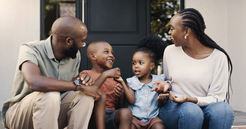 Black family, happy and talking on porch with children for bonding, playing or conversation. Smile, relax and African mother, father and kids at house outdoor for communication or speaking together