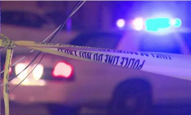 A police car that has its lights on with caution tape in the image