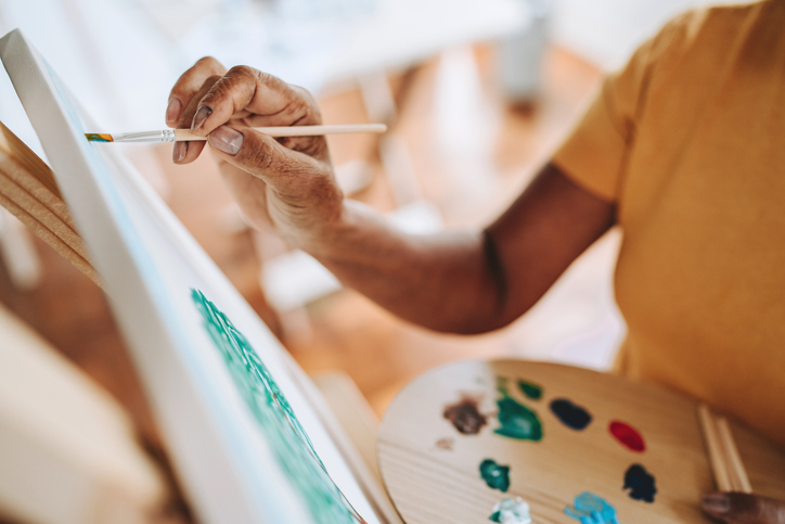 Close-up of hands painting a picture in the painting studio