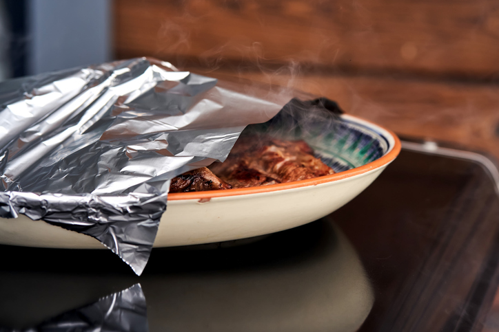 A plate of BBQ ribs on a gas grill.