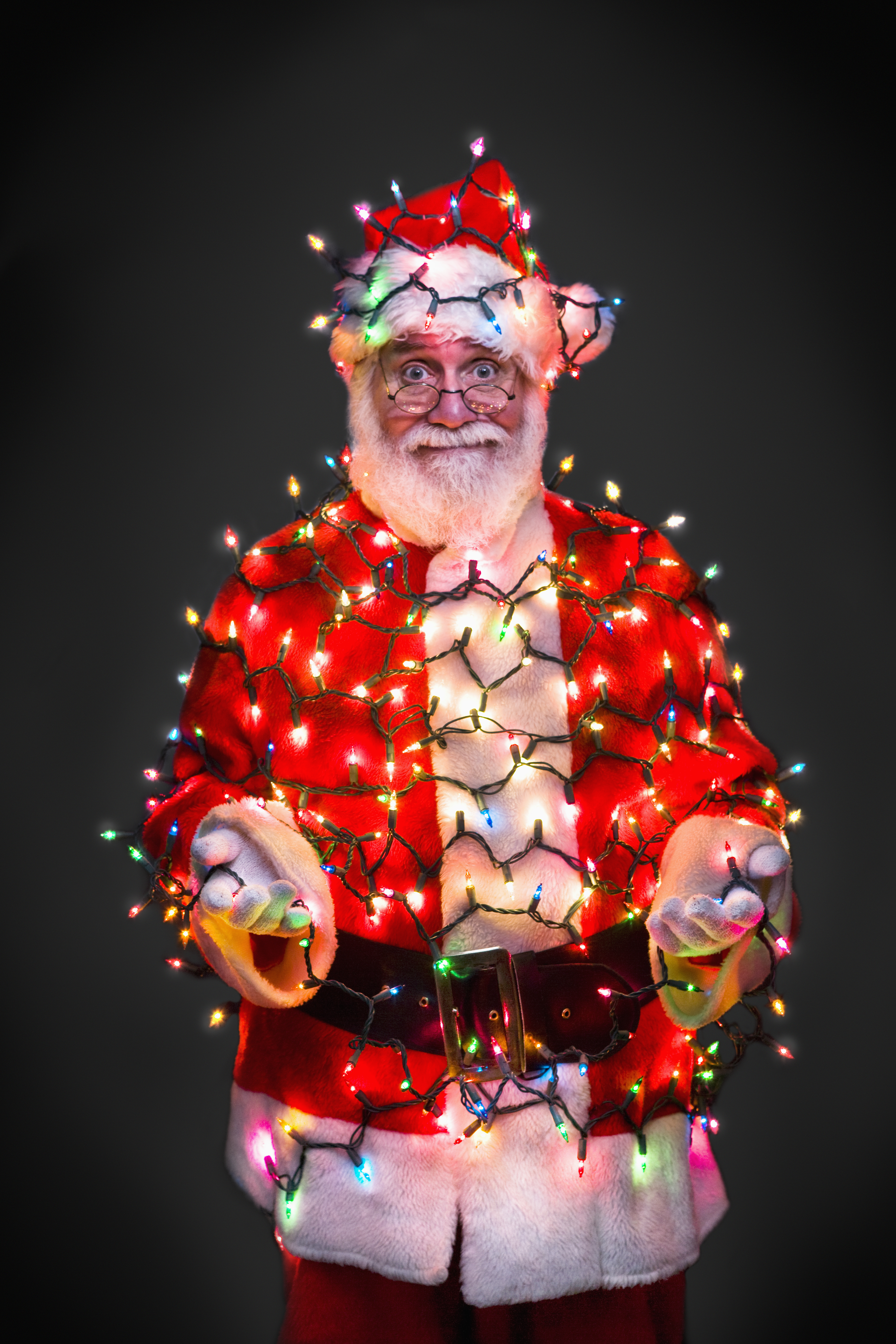 Santa Claus wrapped in Christmas lights