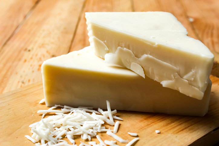 cheese on a cutting board on a wooden table