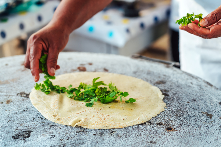 Hands Preparing Tortilla with Cilantro in Oaxaca