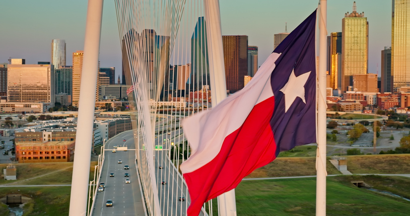 Texas State Flag Flying Over Margaret Hunt Hill Bridge and Downtown Dallas Skyline