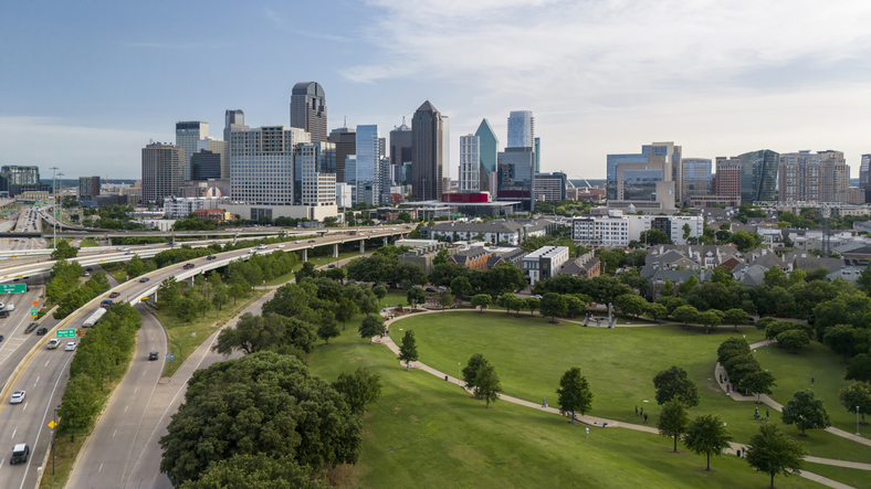 Dallas Business skyline rises above lush parks stretching along North Central Expressway in Texas