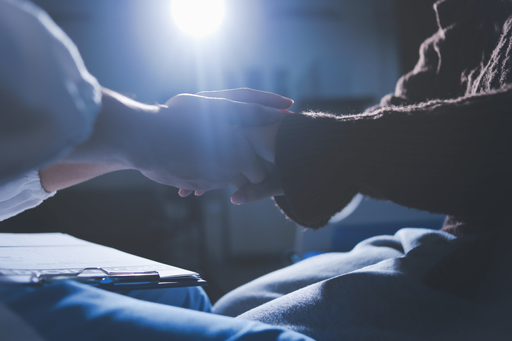 A female nurse caregiver holds hands to encourage and comfort an elderly woman. For care and trust in nursing homes for people of retirement age Caregiver helping elderly woman provides medical advice