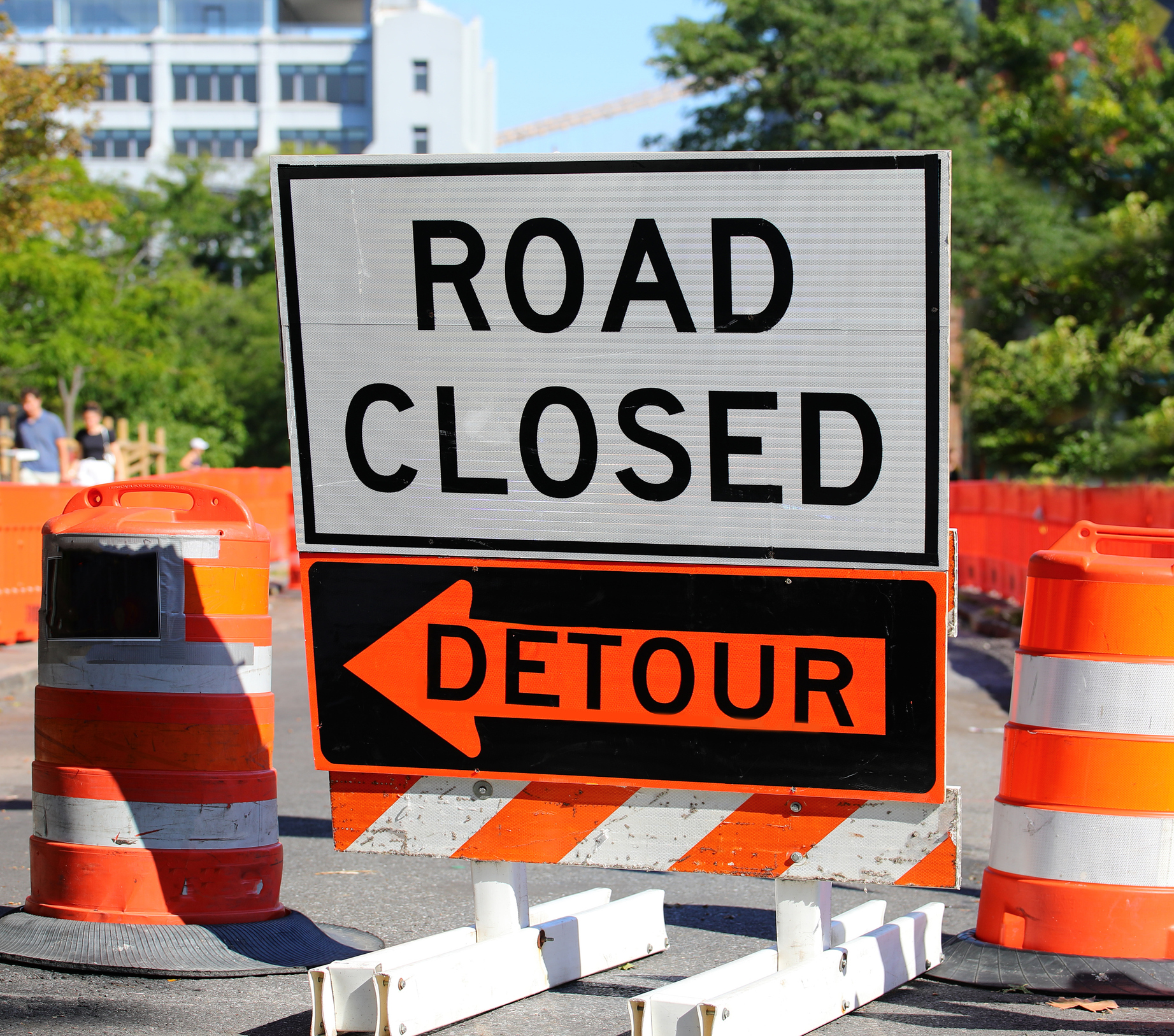road construction site with the sign ROAD CLOSED and the detour arrow in the American city