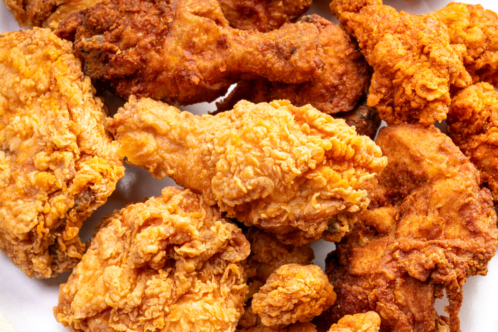 Crispy golden fried chicken served in a takeaway plate, Concept for online food delivery, fast casual dining, quick takeaway service, and digital menu advertising.