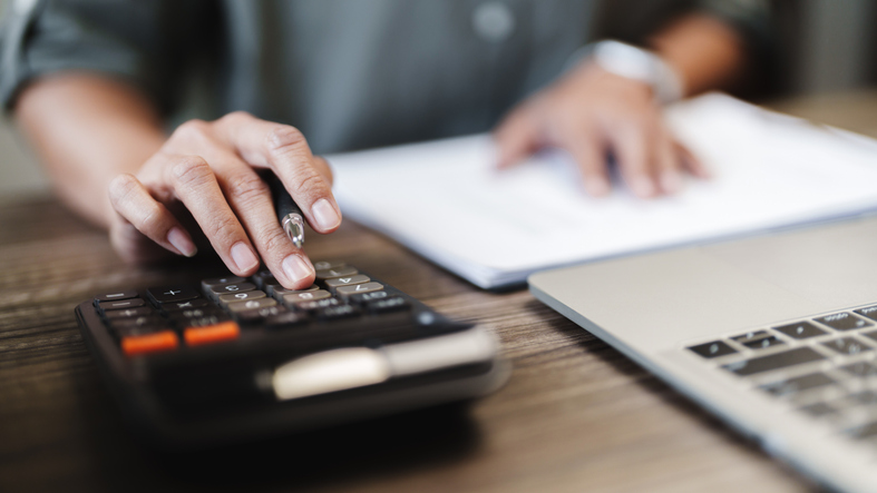 Female calculating personal financial for future plan at her home, taxes payment.